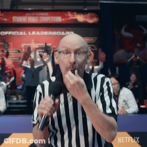 A Referee In A Striped Shirt Is Holding A Microphone And Eating A Snack . GIF