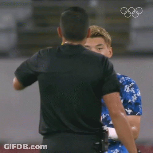 A Referee Is Giving A Yellow Card To A Player In A Blue Shirt GIF