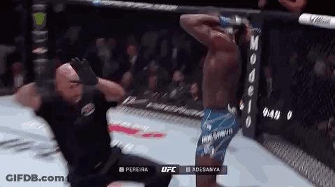 A Referee Is Kneeling Down In Front Of A Fighter In A Boxing Ring . GIF