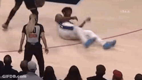 A Referee Is Standing Next To A Basketball Player On The Court . GIF