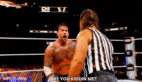 A Referee Is Standing Next To A Wrestler In A Wrestling Ring And Asking Him If He Is Kidding Him . GIF