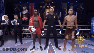 A Referee Stands Between Two Boxers One Of Whom Is Wearing A Pereira Shirt GIF