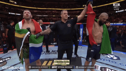 A Referee Stands Between Two Fighters During A UFC Fight GIF