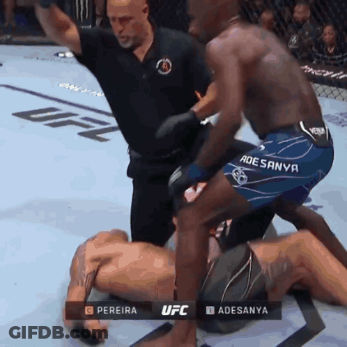A Referee Stands Between Two Fighters In A Ufc Fight GIF