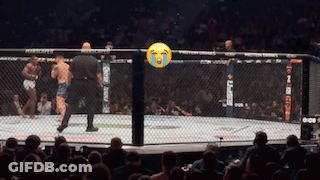 A Referee Stands In A Boxing Ring With A Tear Coming Out Of His Eyes GIF