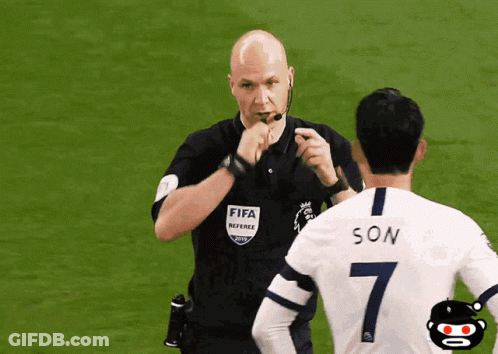 A Referee Wearing A Fifa Referee Shirt Talks To A Soccer Player Wearing A Number 7 GIF