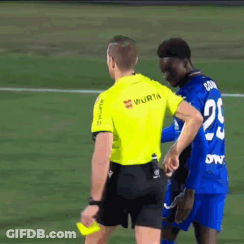 A Referee Wearing A Yellow Shirt That Says Wurth GIF