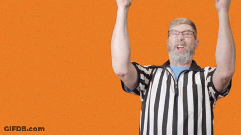 A Referee With His Arms In The Air And The Word Goal In The Background GIF