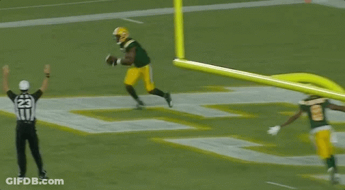 A Referee With The Number 22 On His Hat Watches A Football Player GIF