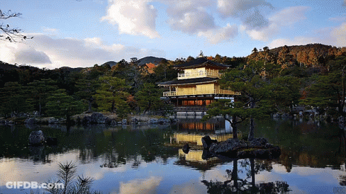 A Reflection Of A Building In A Body Of Water GIF