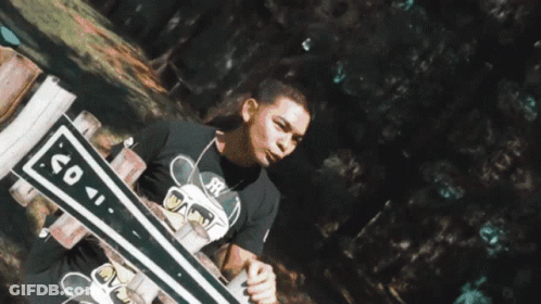 A Reflection Of A Person In A Puddle Of Water With Trees In The Background GIF