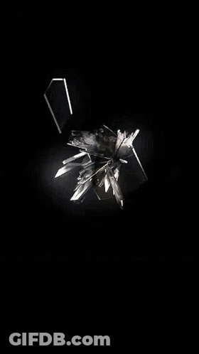A Reflection Of A Person 'S Face In A Broken Glass GIF