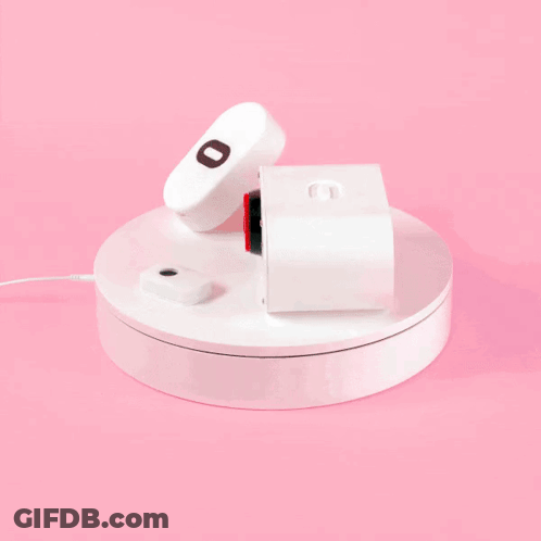 A Remote Control With The Letter O On It Sits On A White Circle GIF