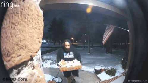 A Ring Camera Shows A Man Carrying A Box Of Domino 'S Pizza GIF