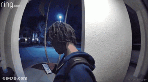 A Ring.com Video Of A Person Looking At Their Phone GIF