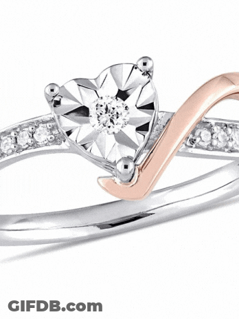 A Ring With A Heart Shaped Diamond In The Middle GIF