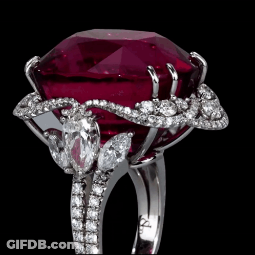 A Ring With A Large Ruby And Diamonds Has The Letters Aa On It GIF