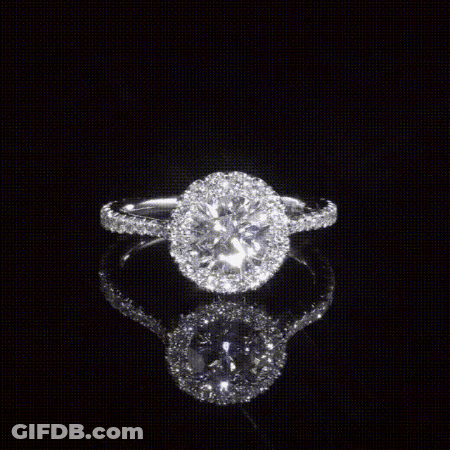 A Ring With A Round Diamond In The Center GIF