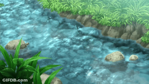 A River Flowing Through A Grassy Area With Rocks In The Water GIF