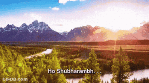 A River Runs Through A Lush Green Forest With Mountains In The Background And The Words Ho Shubharambh In The Foreground GIF