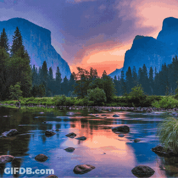 A River With Mountains In The Background And A Sunset In The Sky GIF
