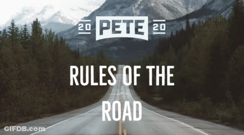 A Road With Mountains In The Background And The Words Rules Of The Road GIF