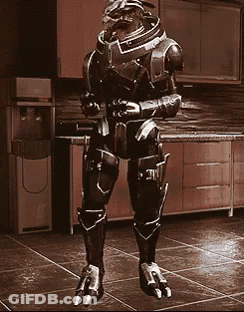 A Robot Is Standing In A Kitchen In Front Of A Water Cooler GIF