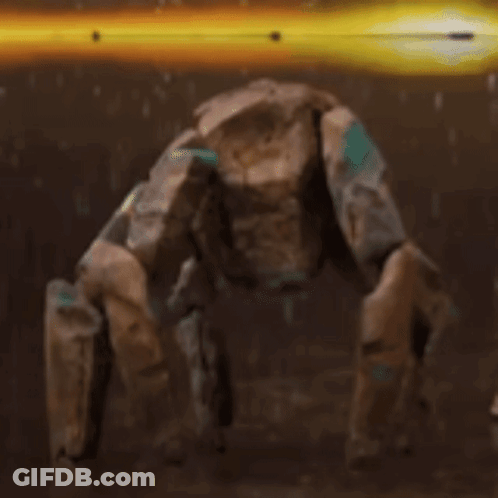 A Robot Is Standing On Its Hind Legs In A Dark Room With A Yellow Light Behind It . GIF