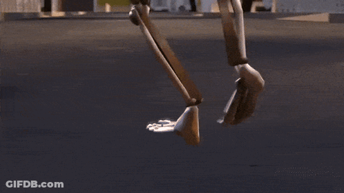 A Robot Is Walking Down A Street In A Video Game GIF