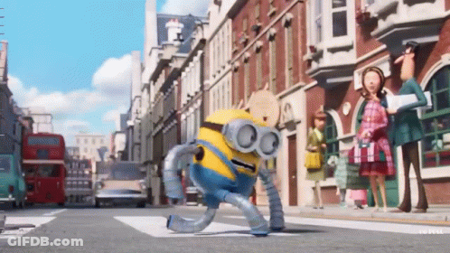 A Robot Minion Is Walking Down A Street GIF