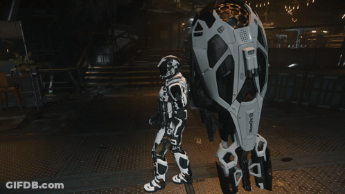 A Robot Standing Next To A Sign That Says Wake Up On It GIF