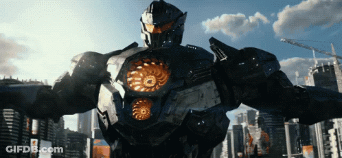 A Robot Stands In Front Of A City With A Blue Sky And Clouds GIF
