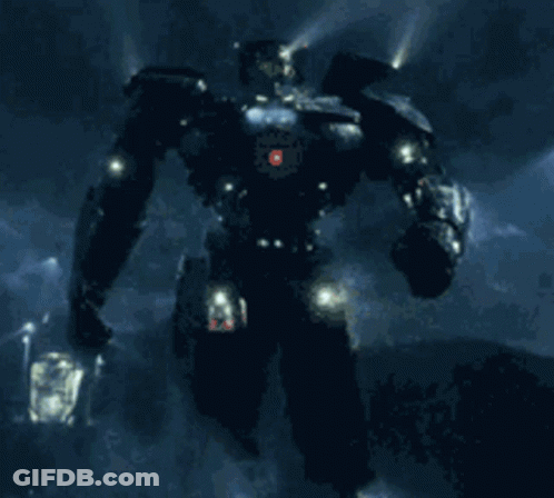 A Robot With A Red Light On Its Head Stands In The Dark GIF