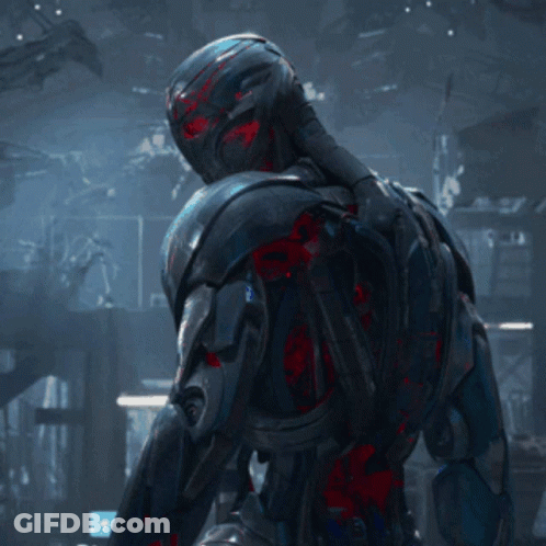 Robot With Red Eyes Standing In Darkness GIF