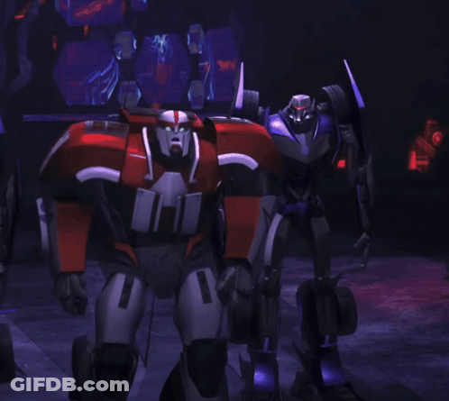 A Robot With The Number 1 On It Stands In A Dark Room GIF