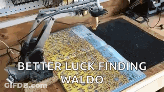 A Robotic Arm Is Sitting On Top Of A Table Next To A Book . GIF