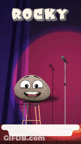 A Rock With A Face Is On A Stool In Front Of A Microphone With The Word Rocky Above It GIF