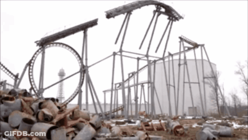 A Roller Coaster Is Being Built In The Middle Of A Pile Of Junk GIF