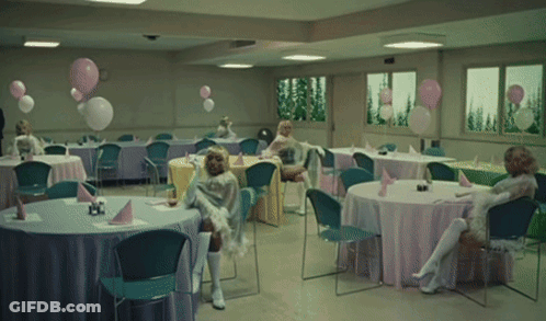 A Room Filled With Tables And Chairs With Balloons On Them GIF