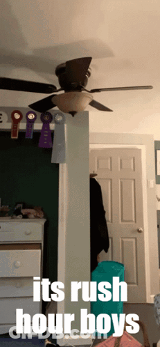 A Room With A Ceiling Fan And The Words " It 'S Rush Hour Boys " On The Bottom GIF
