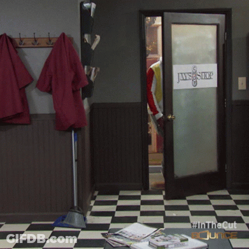 A Room With A Checkered Floor And A Door That Says Jaws Shop GIF