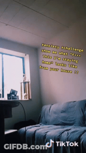 A Room With A Couch And A Window With A Tik Tok Sticker On The Wall GIF