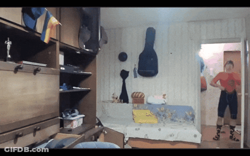 A Room With A Guitar Case On The Wall GIF