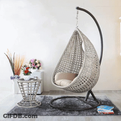 A Room With A Hanging Chair And A Table GIF