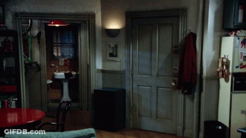 A Room With A Sink And A Refrigerator With A Picture Of Superman On It GIF