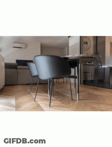 A Room With A Table And Chairs And A Couch GIF