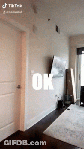 A Room With A Tv On The Wall And The Word Ok Written On It GIF