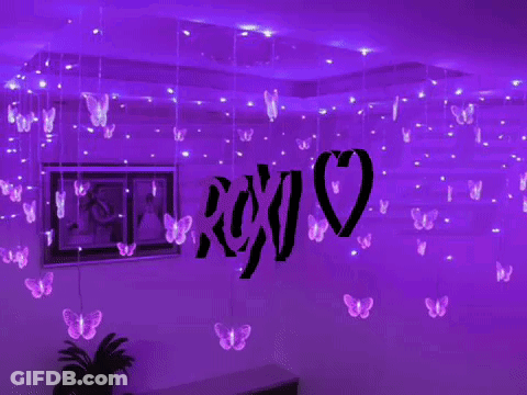A Room With Purple Lights Hanging From The Ceiling And A Sign That Says Xoxo GIF