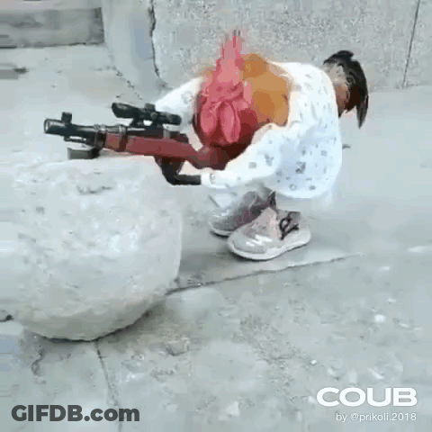 A Rooster Is Holding A Gun Next To A Snowball On The Sidewalk . GIF