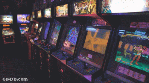 A Row Of Arcade Machines With One That Says Capcom GIF